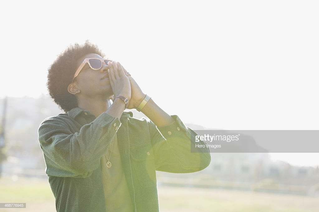 Man standing outdoors praying